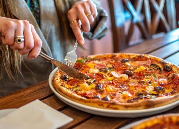 A pizza being cut at Venice